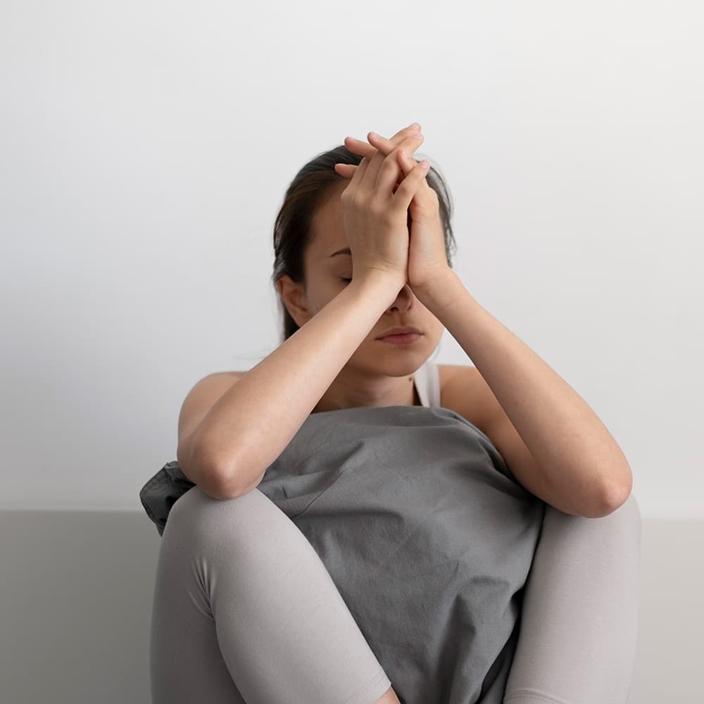 Sad woman holding a pillow