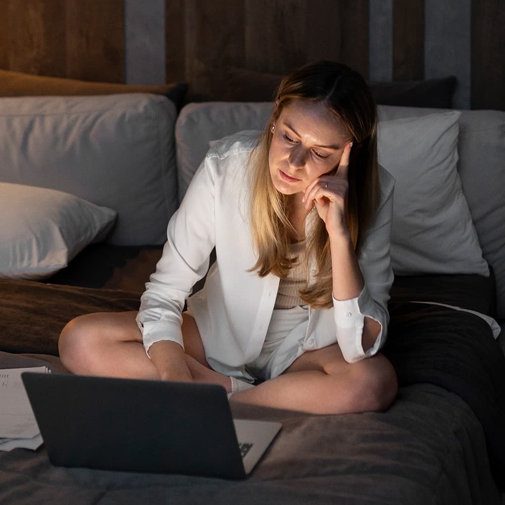 Woman using laptop late into the night